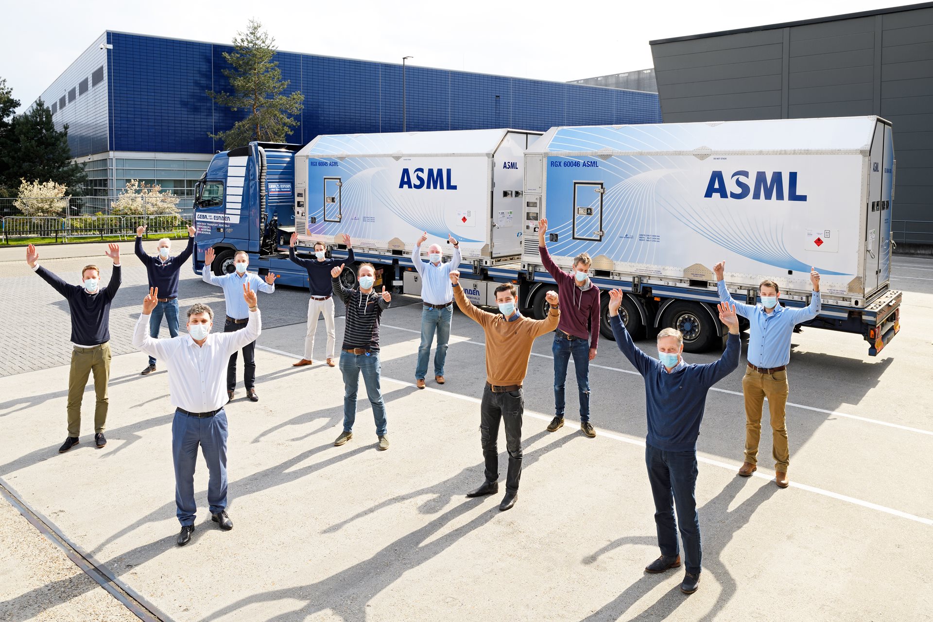 ASMLengineers celebrate first shipment through pilot program, stand before system on the truck.“data-focal-point=